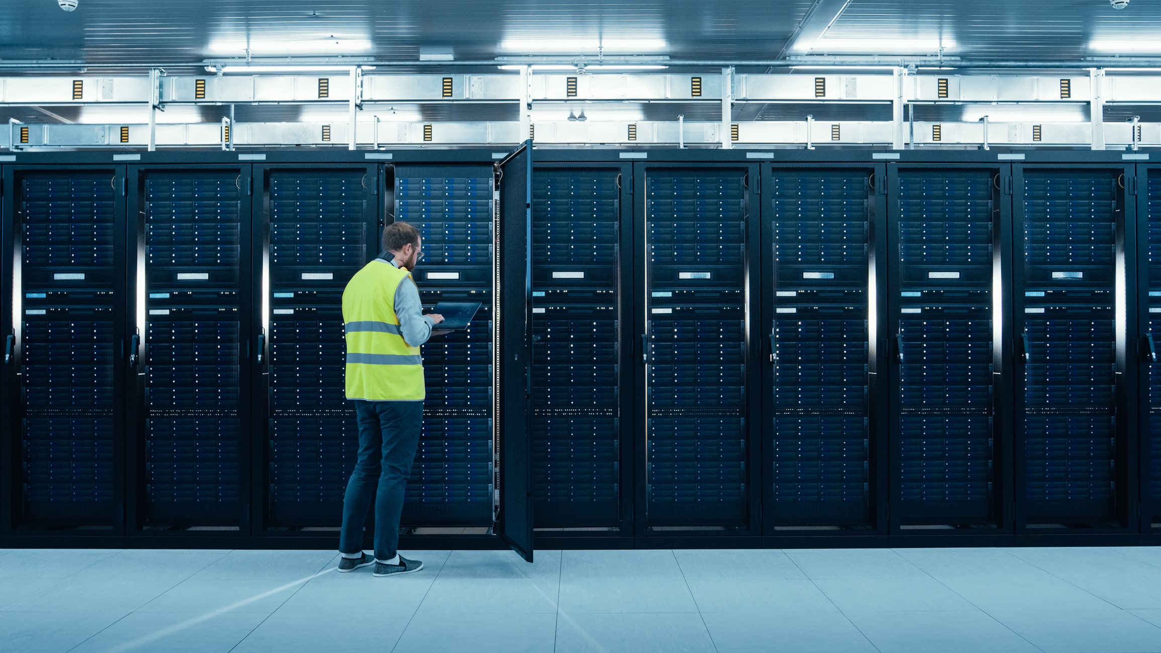 IT expert standing in front of a server rack