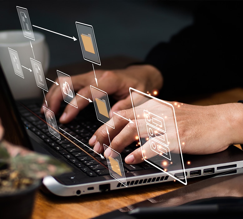 A person typing on a laptop with a business graph on the screen, showcasing how to use a laptop for business purposes