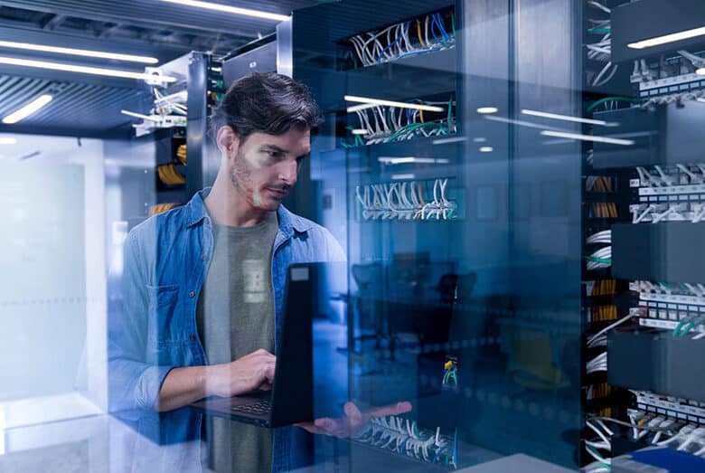 A person standing near a server rack