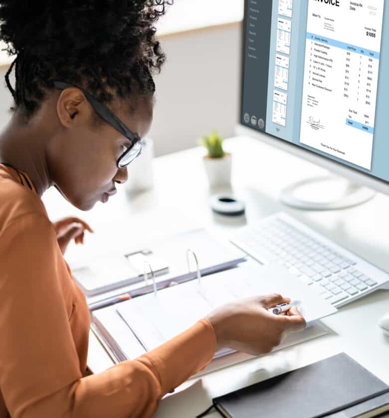 Female professional using computer for accounting tasks