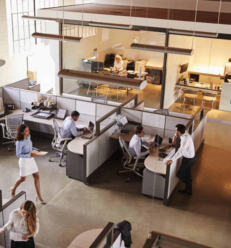 People in an office engaged in their tasks at individual desks