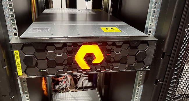 Server rack with yellow sign, indicating important information for maintenance and organization