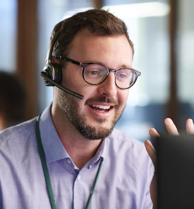 Person wearing headset and glasses speaking on the phone